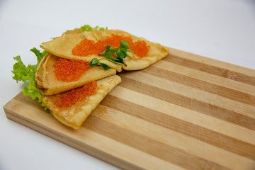 Traditional Russian pancakes with red caviar