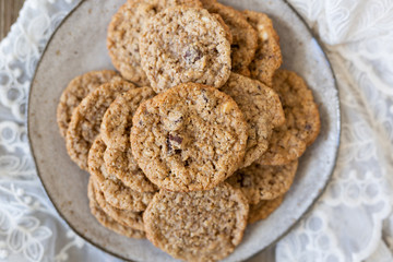 Oatmeal cookies on plate with lace and wood