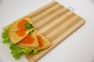 Traditional Russian pancakes with red caviar