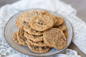 Oatmeal cookies on plate with lace and wood