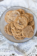 Oatmeal cookies on plate with lace and wood