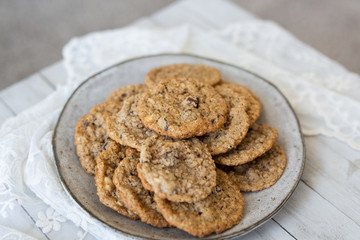 Oatmeal cookies on plate with lace and wood