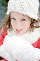 Winter time. Cute child enjoying winter atmosphere with snow.