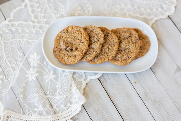 Oatmeal cookies on plate with lace and wood