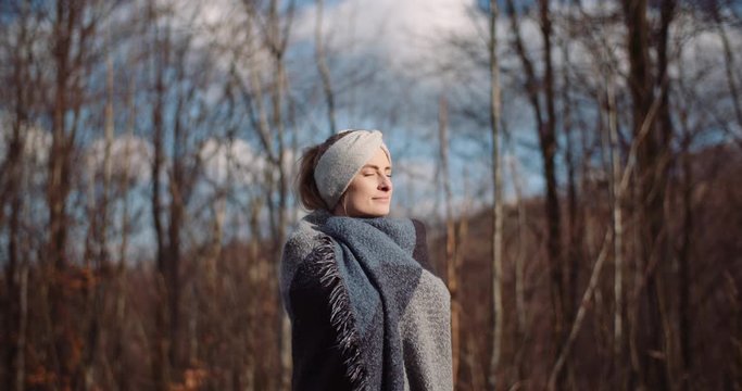 hapy woman smiling into camera in autumn