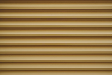 detail of stripped metal garage or store door; metal background and texture for designers