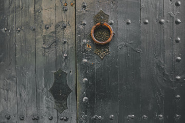 old rustic door knocker in a wooden door