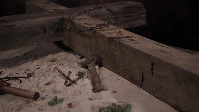 4K: Crown of thorns on Cross of Jesus Christ at Easter. Tracking shot of the crucifixion scene with Nails, Hammer & Blood. Stock Video Clip Footage