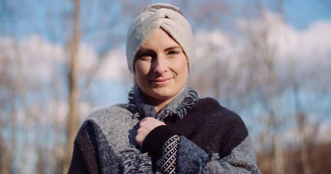 hapy woman smiling into camera in autumn