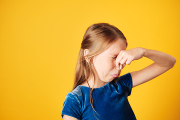Little Redhead Girl Covering Nose For Bad Smell - obrazy, fototapety, plakaty