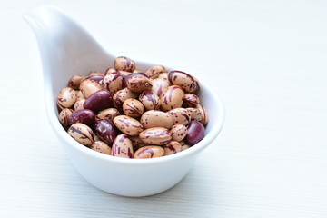 Raw bean grains (Phaseolus vulgaris) displayed in bowl