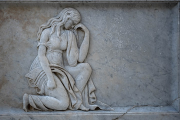 Fototapeta na wymiar Female Embossed Statue. Sculpture Wallpaper 3D Embossed of a woman in Preveza Epirus Greece, Metropolitan Temple.