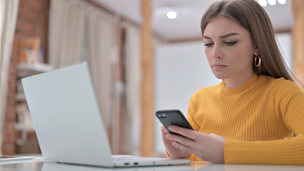 Young Woman Using Smartphone for Work