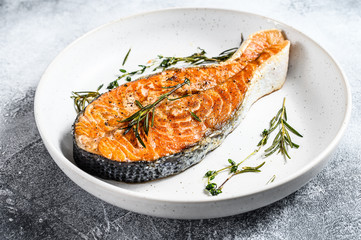 Roasted salmon steak. Healthy seafood. Gray background. Top view