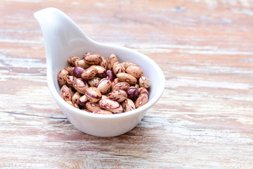 Raw bean grains (Phaseolus vulgaris) displayed in bowl