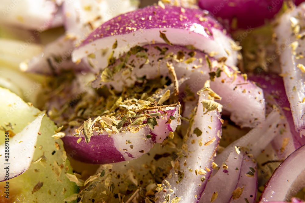 Wall mural closeup of fresh salad with onions cucumber and oregano