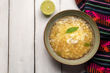 Mexican corn grain boiled also called esquites with cheese and mayonnaise on white background