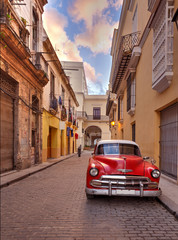 Antique American Red and White Car Parked in on a Street in Cuba