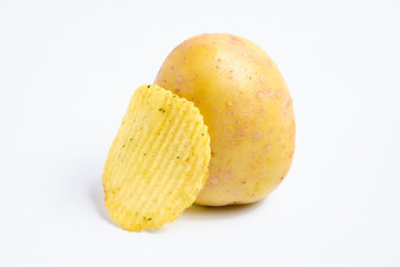 Fluted chips with spices leaned on peeled potatoes on a white background. Isolated.
