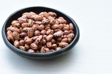 Raw bean grains (Phaseolus vulgaris) displayed in bowl
