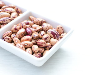 Raw bean grains (Phaseolus vulgaris) displayed in bowl