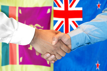 Handshake on Sri Lanka and New Zealand flag background.