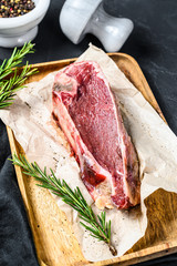 Raw beef cut with bone. Black background. Top view