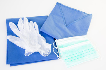 medical gloves with protective clothes and mask with coronavirus COVID-19 concept for nurse and doctor uniform