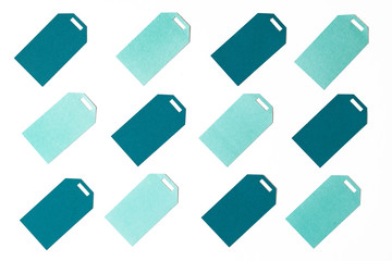 Teal and mint colored gift tags on white background