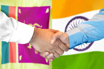 Business handshake on the background of two flags. Men handshake on the background of the Sri Lanka and India flag. Support concept