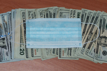 Medical mask and US dollars money. Concept of increasing the price of medical masks.