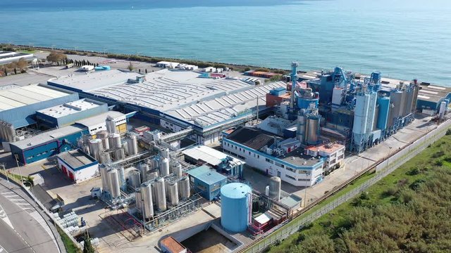 Aerial panoramic view of chemical process plant on Mediterranean coast near Mataro, Catalonia, Spain