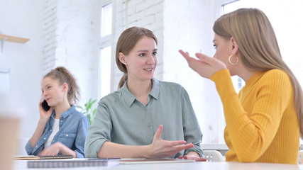 Talking Young Women Discussing at Work