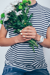 Unrecognizable young woman holding bouquet