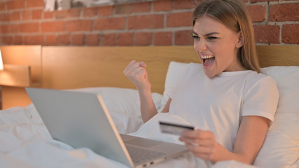 Young Female Celebrating Online Payment Success on Laptop