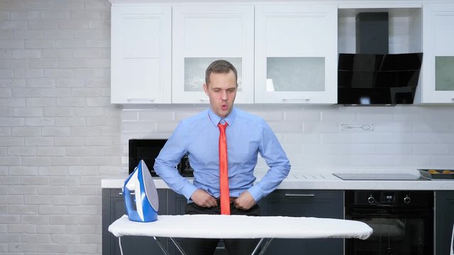 weight loss concept. man hardly fastens his pants, on a thick stomach