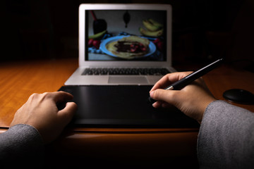 Girl working with graphic tablet and laptop