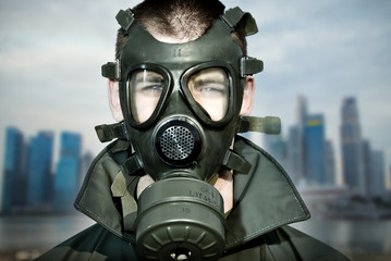 environmental disaster and pollution wearing gas mask skyscrapers in background