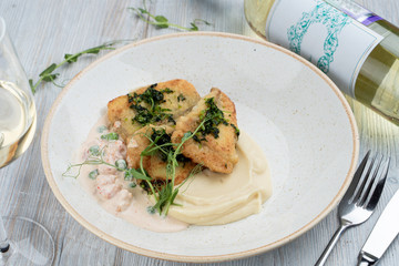 Pike perch fillet, fried in ghee with lemon balm, served with creamy mashed potato and prawns sauce