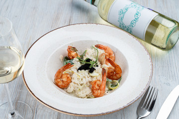 Shrimp risotto with ginger and lemongrass, decorated with black caviar
