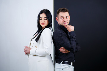 guy in a black shirt and a girl in a white jacket on a black and white background