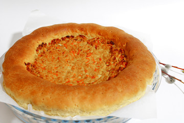 Large baked meat pie on a white background