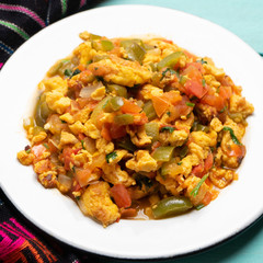 Mexican scrambled eggs with tomato and chili pepper also called 