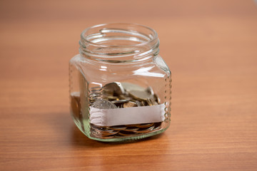 Mockup with empty paper in glass bottle with coins