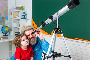 Pupil studies astronomy with funny teacher. Teachers day. Educational process.