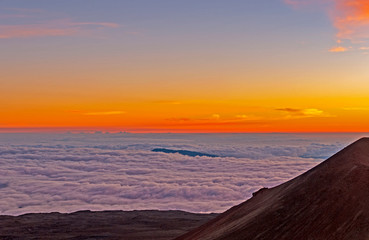 Sunset Above the Clouds in the High Mountains
