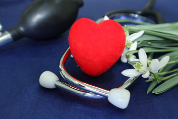 Tonometer and red heart on a blue background