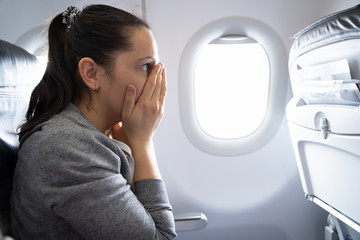 Woman Having Anxiety Attack In Airplane