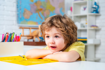 Cute face of pupil, close up. Learning and education concept. Cute child boy in classroom.