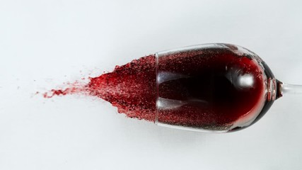 Super Slow Motion Top Shot of Falling Glass with Red Wine on White Cloth at 1000fps.